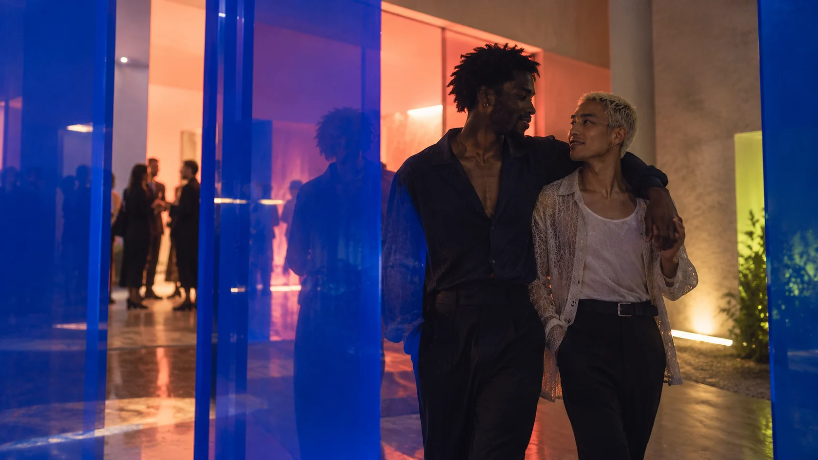 A couple walking together through a modern event space